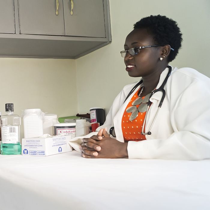 A school nurse talking with a student in Kenya